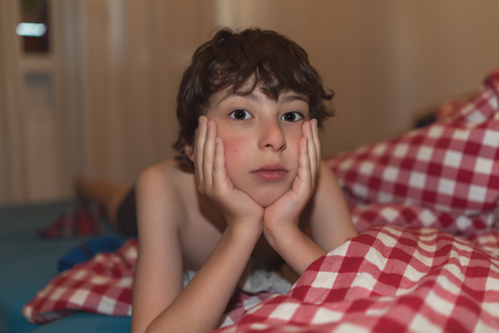 Portrait of a boy on the bed.の写真素材