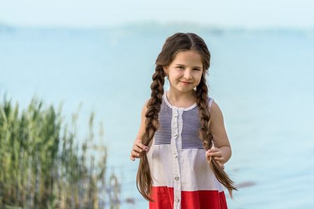 Portrait of a beautiful girl by the lake.の写真素材