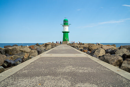 WARNEMUENDE (ROSTOCK), GERMANY - JULY 25, 2019: Lighthouse in front of the entrance to the waters of the sea port of Rostock - Warnemuende.のeditorial素材