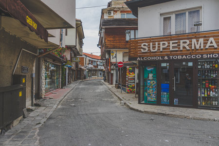 NESSEBAR, BULGARIA - JUNE 22, 2019: Beautiful and narrow street with restaurants, cafes and shops of the ancient seaside town. Deserted streets in the early morning. Toning. Stylization.のeditorial素材
