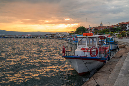 NESSEBAR, BULGARIA - JUNE 22, 2019: Bay of Sozopol in the early morning. Pleasure boat stands near the pier.のeditorial素材