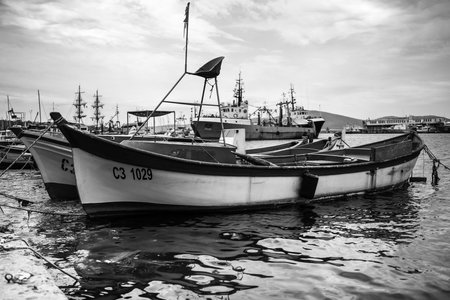 SOZOPOL, BULGARIA - JUNE 28, 2019: Fishing boats at the seaport are at the pier. Black and white.のeditorial素材
