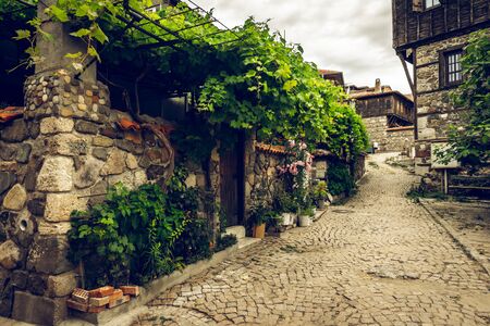 Narrow streets of an ancient seaside town of Sozopol on the southern Bulgarian Black Sea Coast. Vintage stylization, tonung.の写真素材