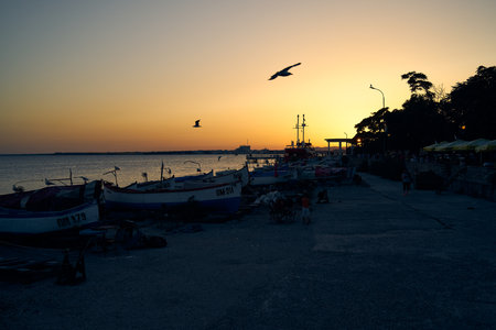 POMORIE, BULGARIA - JUNE 30, 2019: Fishing boats stand in the sunset light on the shore of the seaport of the seaside resort town of Pomorie.のeditorial素材