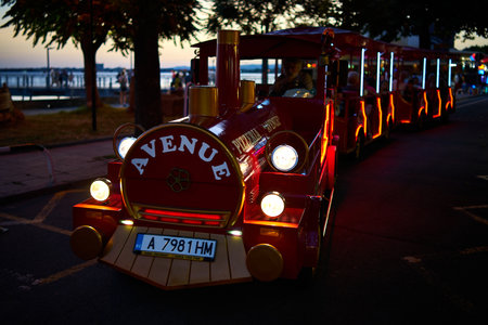 POMORIE, BULGARIA - JUNE 30, 2019: Tourist road train. Drive around the historic city center. Entertainment for tourists.のeditorial素材