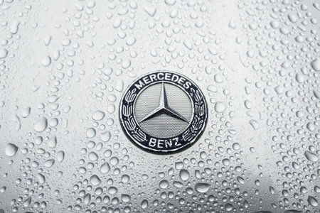BERLIN - AUGUST 18, 2019: The modern hood emblem of Mercedes-Benz car in raindrops.のeditorial素材