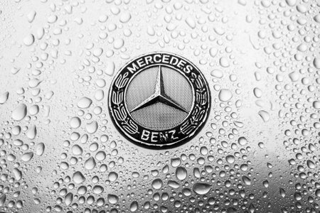 BERLIN - AUGUST 18, 2019: The modern hood emblem of Mercedes-Benz car in raindrops. Black and white.のeditorial素材