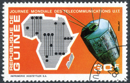 GUINEA - CIRCA 1972: A stamp printed in Guinea, dedicated to 4th World Telecommunications Day, depicted the Map of Africa and Relay Satellites, circa 1972のeditorial素材