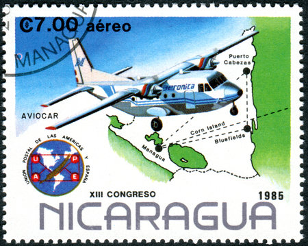 NICARAGUA - CIRCA 1985: A stamp printed in Nicaragua, dedicated to 13th Congress Postal Union of the Americas and Spain, depicted the Monoplane and Nicaraguan air network, circa 1985のeditorial素材