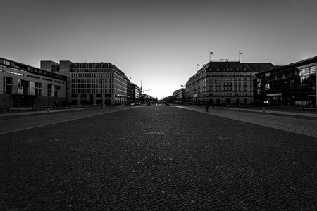 BERLIN - MARCH 22, 2020: The five-star Hotel Adlon, Pariser Platz (Paris Square) near by Brandenburg Gate and boulevard Unter den Linden. Desert area caused by quarantine as a result of coronavirus infection. Black and white.のeditorial素材