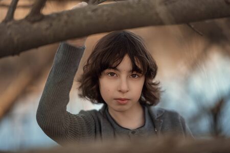 Portrait of a handsome boy on a background of nature. Face close-up.
