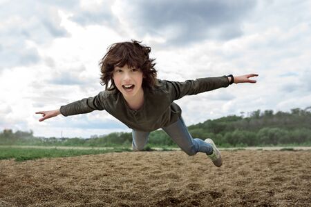 Joyful boy in flight (levitation effect).の写真素材