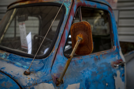 BERLIN - MAY 05, 2018: Detail of full-size pickup truck Ford F-100 (second generation). Rusty exterior rearview mirror.のeditorial素材