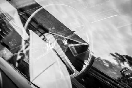 The interior of retro car. View through the glass. Black and white.