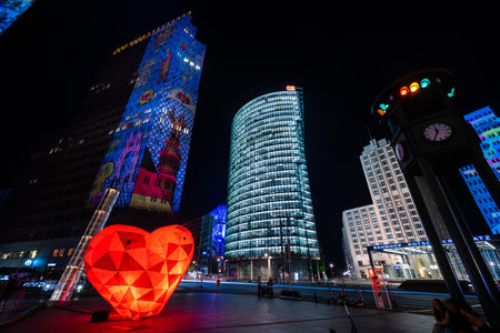 BERLIN - OCTOBER 15, 2020: Modern skyscraper at Potsdamer Platz in brightly colored illuminations. Festival of lights 2020.のeditorial素材