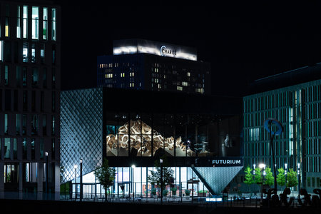 BERLIN - SEPTEMBER 15, 2020: The famous Charite Clinic (background) and the Futurium building (foreground) in the evening backlight illuminations.のeditorial素材