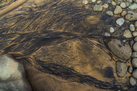 Abstract natural patterns on wet sand. Background.