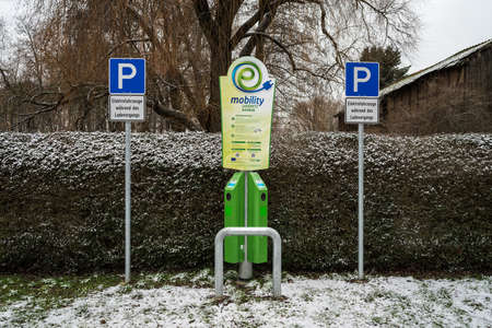 TUCHEN, GERMANY - FEBRUAR 04, 2021: Electric car charging station in a public parking lot.のeditorial素材