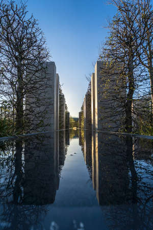 Pylons reflecting in the water and receding into the distance. Abstract architecture.