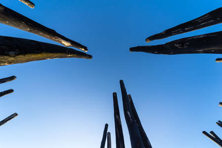 Old wooden pillars against the sky. Background.