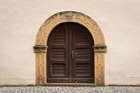An old arched double-leaf door.の写真素材