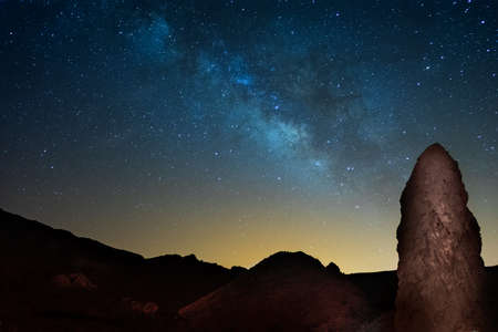 The night sky and Milky Way. The rock Roques de Garcia on the foreground. Tenerife, Canary islands. Spain.の写真素材