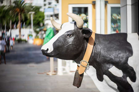 PUERTO DE LA CRUZ, SPAIN - JULY 02, 2021: Cow - the symbol of the Spanish chain stores of gifts and accessories ALE-HOP. Tenerife, Canary Islands.のeditorial素材