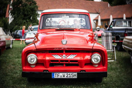 DIEDERSDORF, GERMANY - AUGUST 21, 2021: Full-size pickup truck Ford F-100 (second generation), 1953. Focus on center. Swirly bokeh. The exhibition of "US Car Classics".のeditorial素材