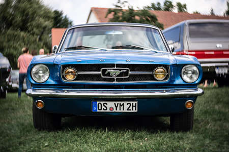 DIEDERSDORF, GERMANY - AUGUST 21, 2021: The iconic sports car Ford Mustang Fastback Coupe. Focus on center. Swirly bokeh. The exhibition of "US Car Classics".のeditorial素材