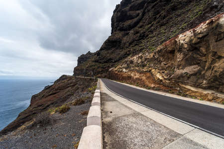 High mountain road at the edge of the ocean.の写真素材