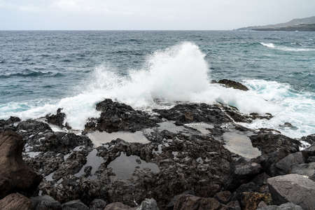 Rocky coast and splashing ocean waves.