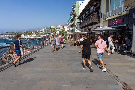 PUERTO DE LA CRUZ, TENERIFE, SPAIN - JULY 14, 2021: Promenade with vacationers and tourists.のeditorial素材