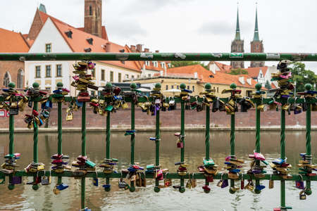 WROCLAW, POLAND - OCTOBER 14, 2021: Padlocks on the fence of the Oder River in the old part of the city. The tradition of lovers.のeditorial素材