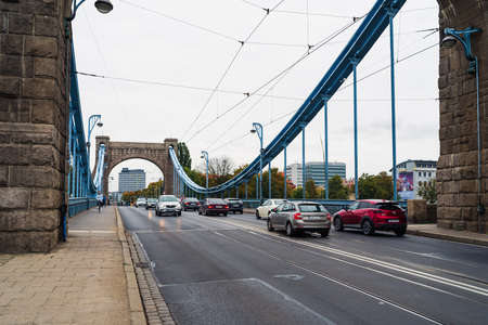 WROCLAW, POLAND - OCTOBER 14, 2021: Grunwald Bridge (1910) - the oldest suspension bridge, symbol of...