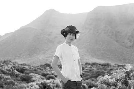 Portrait of a teenager against the backdrop of the Los Gigantes cliffs. View from cape Teno. Tenerife. Canary Islands. Spain. Black and white.の写真素材