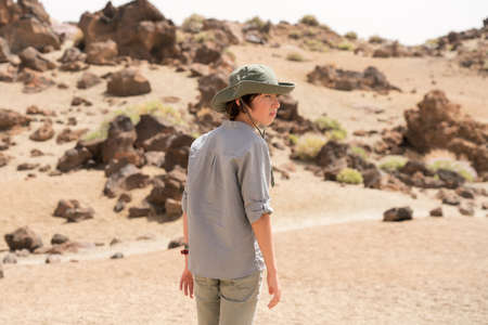 Portrait of a teenager on the background of rocks.