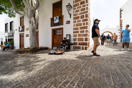 TEGUISE (village), LANZAROTE, CANARY ISLANDS - JULY 17, 2022: Street musician (hang drum) in the old part of the village. Until 1852, Teguise was the capital of the island.のeditorial素材