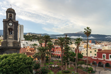View on the old town of Puerto de la Cruz and the church of Nuestra Senora de la Pena de Francia. In the background is the Teide volcano. Tenerife. Canary Islands. Spain.のeditorial素材