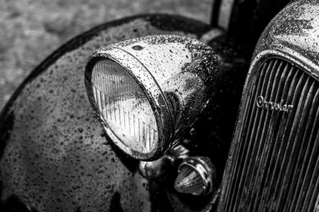 FINOWFURT, GERMANY - MAY 06, 2023: Fragment of the full-size car Plymouth De Luxe in drops of rain, 1934. Black and white. Race festival 2023. Season opening.のeditorial素材