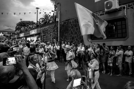 PUERTO DE LA CRUZ, SPAIN - JULY 16, 2023: Procession in honor of Our Lady of Mount Carmel through the streets of the town. Black and white.のeditorial素材