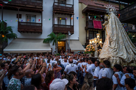 PUERTO DE LA CRUZ, SPAIN - JULY 16, 2023: Procession in honor of Our Lady of Mount Carmel through the streets of the town.のeditorial素材