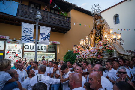 PUERTO DE LA CRUZ, SPAIN - JULY 16, 2023: Procession in honor of Our Lady of Mount Carmel through the streets of the town.のeditorial素材