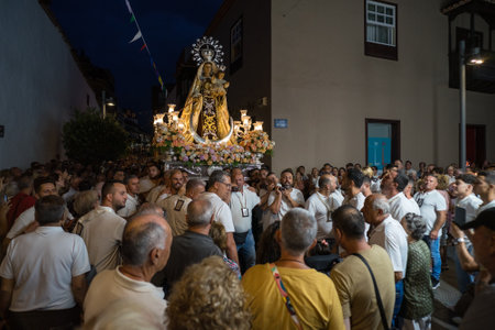 PUERTO DE LA CRUZ, SPAIN - JULY 16, 2023: Procession in honor of Our Lady of Mount Carmel through the streets of the town.のeditorial素材