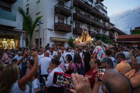 PUERTO DE LA CRUZ, SPAIN - JULY 16, 2023: Procession in honor of Our Lady of Mount Carmel through the streets of the town.のeditorial素材
