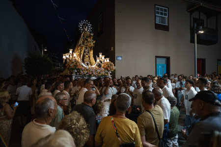 PUERTO DE LA CRUZ, SPAIN - JULY 16, 2023: Procession in honor of Our Lady of Mount Carmel through the streets of the town.のeditorial素材