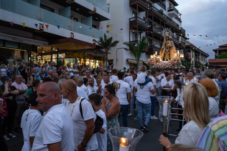 PUERTO DE LA CRUZ, SPAIN - JULY 16, 2023: Procession in honor of Our Lady of Mount Carmel through the streets of the town.のeditorial素材