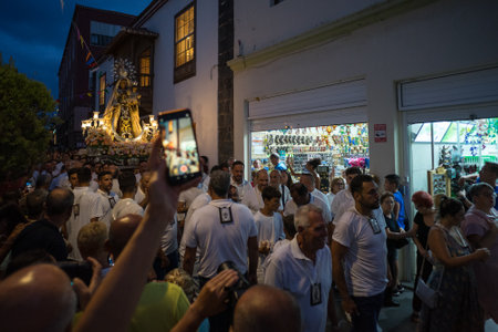 PUERTO DE LA CRUZ, SPAIN - JULY 16, 2023: Procession in honor of Our Lady of Mount Carmel through the streets of the town.のeditorial素材