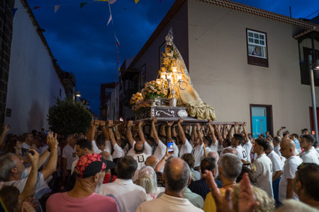 PUERTO DE LA CRUZ, SPAIN - JULY 16, 2023: Procession in honor of Our Lady of Mount Carmel through the streets of the town.のeditorial素材