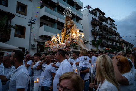 PUERTO DE LA CRUZ, SPAIN - JULY 16, 2023: Procession in honor of Our Lady of Mount Carmel through the streets of the town.のeditorial素材