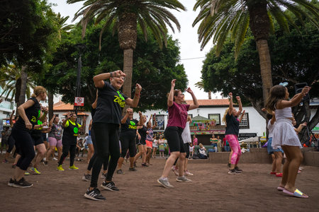 PUERTO DE LA CRUZ, SPAIN - JULY 19, 2023: Group Zumba fitness dance class in the public city park...